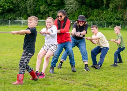 Northern Roots-Group of young people all pulling on a rope together in game
