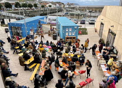 Onion Collective-People in Watchet watch an outdoor performance at East Quay, a community-led development
