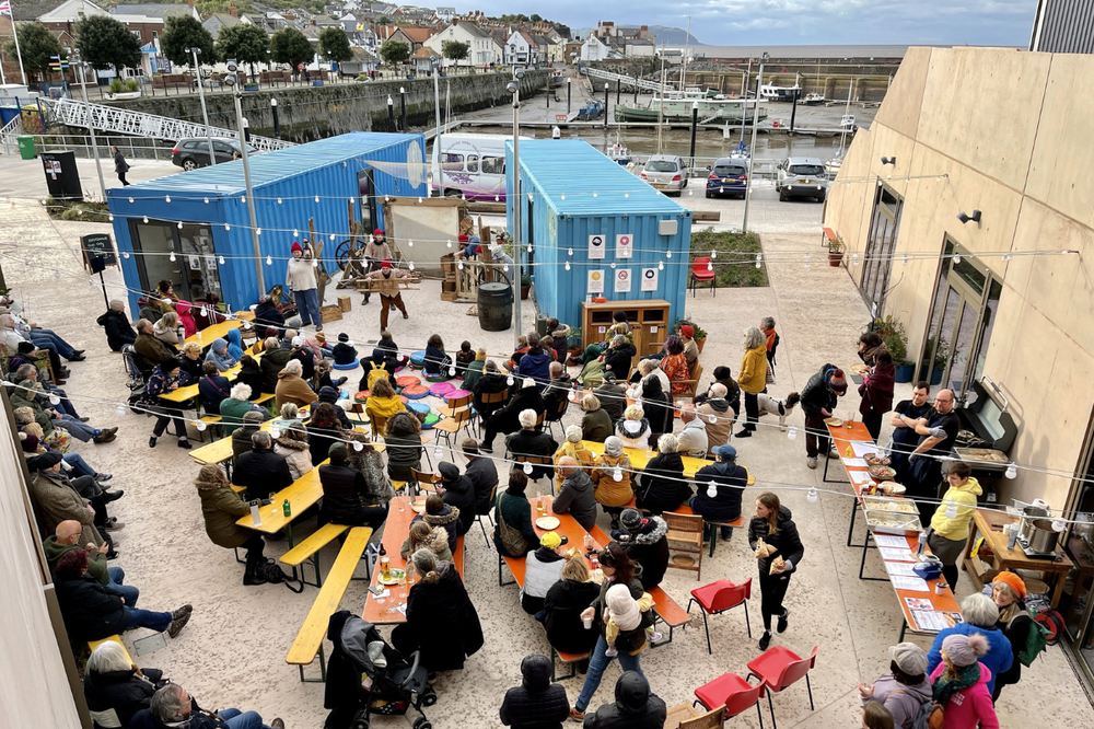 Onion Collective-People in Watchet watch an outdoor performance at East Quay, a community-led development